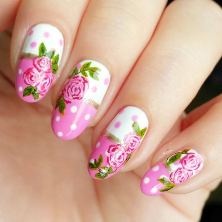 nail art design dedicata alla primavera con smalto e rose rose, smalto bianco e foglie verdi 